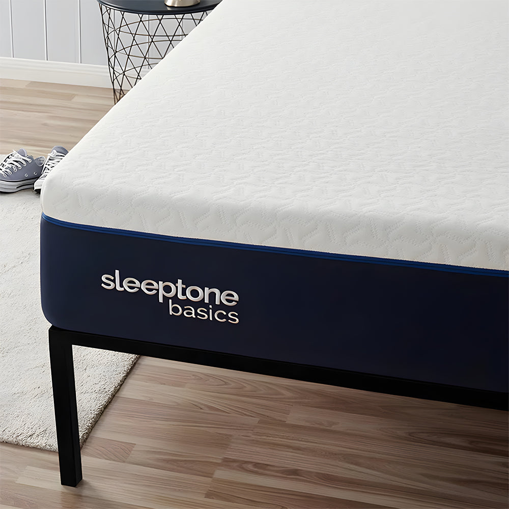 Detailed corner view of the Sleeptone Basics memory foam mattress featuring a navy blue border and premium textured white cover on a black metal frame.
