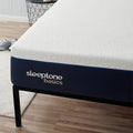Detailed corner view of the Sleeptone Basics memory foam mattress featuring a navy blue border and premium textured white cover on a black metal frame.
