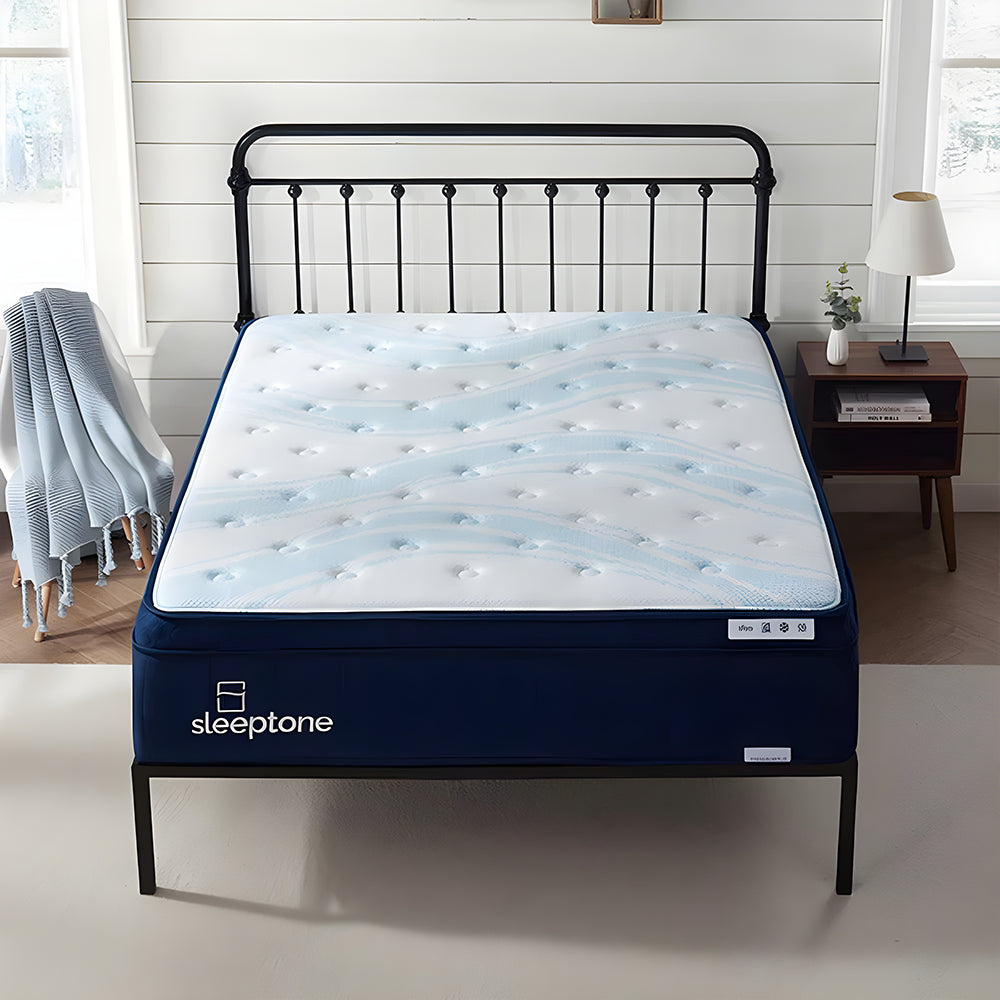 Front view of the Sleeptone 14-inch hybrid coil mattress on a black metal bed frame, featuring a cooling wave-quilted top and premium navy blue side panels.
