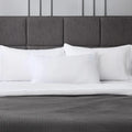 Three Malouf Gelled Microfiber Z pillows on a bed, offering luxury hotel-quality comfort at home.

