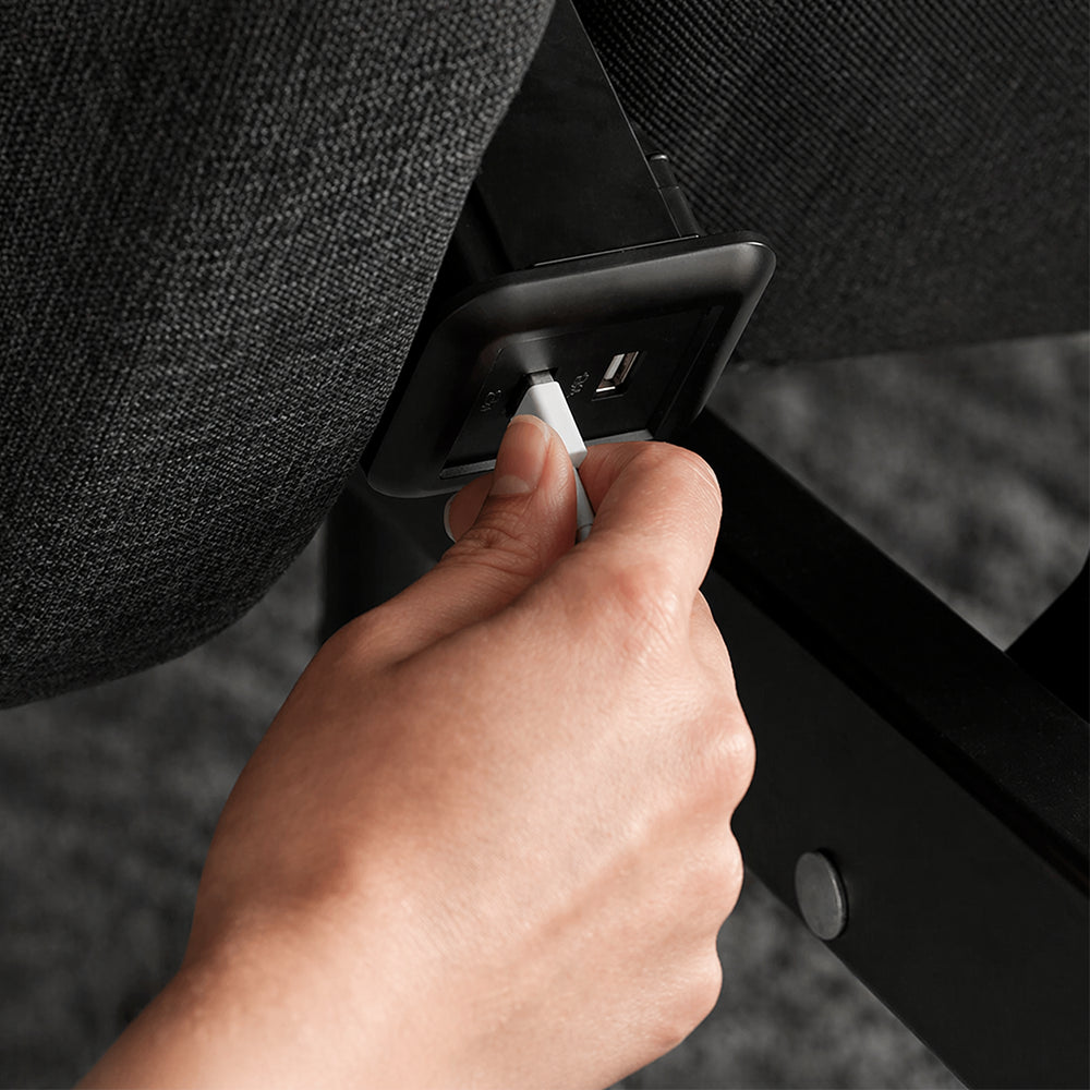 Close-up of the built-in USB charging port on the side of the SleepTone S5000 adjustable bed frame for convenient mobile device charging.
