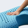 Hand pressing blue ActiveDough memory foam, showing the responsive and plush feel of the Malouf shoulder pillow.
