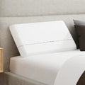 Essentials Dual Air-Foam Pillow by South Bay styled on a bed for a cool and supportive night's sleep.
