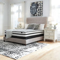 Stylish bedroom setup featuring the Chime Hybrid 10 inch medium mattress by Ashley for restful sleep.
