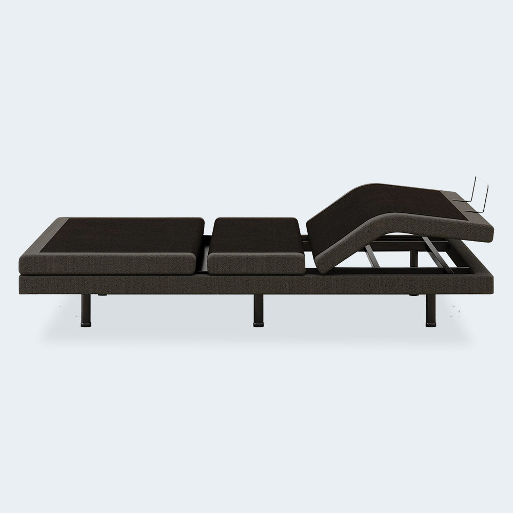 Side view of the Ashley Comfort Ultra adjustable bed foundation demonstrating independent motorized articulation points.
