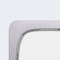 BEDGEAR Powerband elastic on a grey Hyper-Wool crib sheet corner for a secure, non-slip fit.

