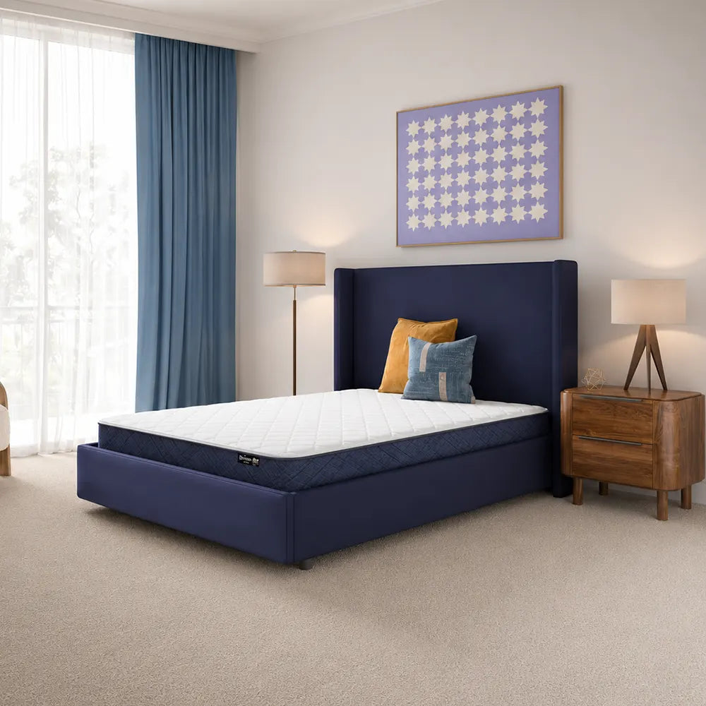 Serta Perfect Day 7 inch firm mattress in a box styled in a contemporary navy blue bedroom.
