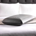 Ergonomic Malouf Zoned Dough charcoal pillow providing plush orthopedic head and neck alignment.

