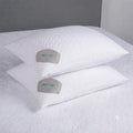 Stacked BEDGEAR Dri-Tec pillow protectors with Air-X ventilation on a white bed for cool, breathable sleep.
