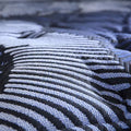 Macro view of the breathable cooling fabric on a Serta Perfect Sleeper X Max Plush Hybrid Mattress.

