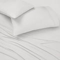 White BEDGEAR Ver-Tex pillowcase set on matching sheets, offering instant cooling and moisture management.
