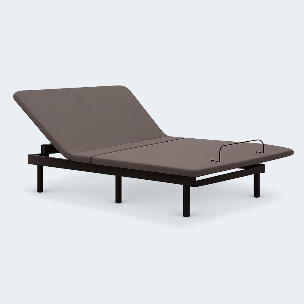 Perspective view of the Ashley Comfort Classic adjustable bed featuring a grey upholstered deck and motorized head-up articulation.
