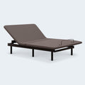 Perspective view of the Ashley Comfort Classic adjustable bed featuring a grey upholstered deck and motorized head-up articulation.
