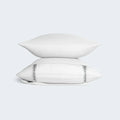 Two stacked white BEDGEAR pillows in Hyper-Wool cases for superior breathability and moisture management.
