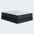 Side view of the Ashley Elite Springs 14-inch firm mattress supported by a sturdy black foundation box spring.
