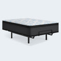 Ashley Elite Springs 14-inch plush mattress displayed on a black metal adjustable power base with a mattress retainer bar.