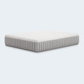 Profile studio shot of the Terra Sleep 12-inch mattress by Ashley Sleep on a black supportive foundation, showcasing its luxury height and sleek border.
