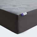 Close-up of the Neve 10" Activair All-Foam Mattress corner featuring a purple brand tag and geometric fabric.