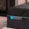 Close-up view of the Ice Cloud Coolsync Hybrid Mattress brand tag on the breathable charcoal fabric cover.