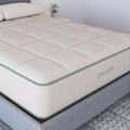 Side profile of the Diamond Mattress Sage Organic Latex hybrid on a grey upholstered bed frame highlighting the breathable organic cotton cover.
