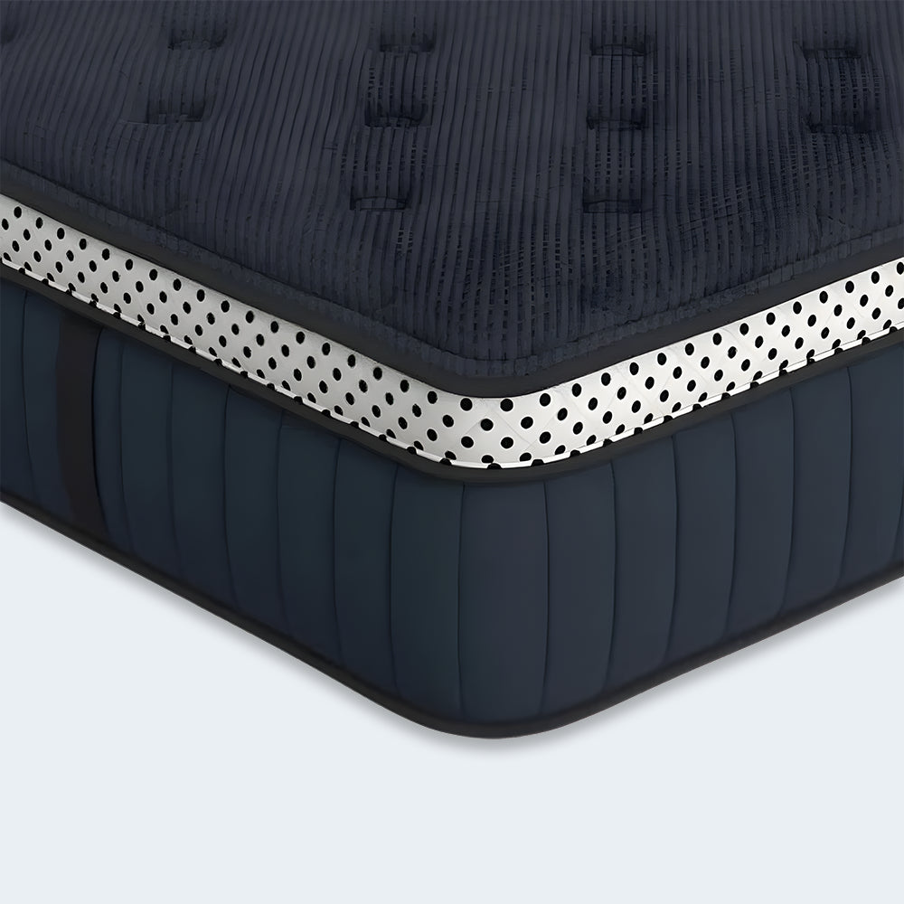 Macro view of the navy blue tufted surface of the WinkBeds Blue 15-inch mattress designed for pressure-relieving comfort and airflow.
