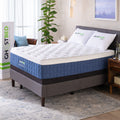 The GhostBed Performance 14-inch cooling hybrid mattress styled on a modern grey upholstered platform bed frame in a bright, contemporary master bedroom.
