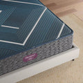 Side sleeper enjoying the contouring support of a Simmons Beautyrest World Class Hybrid Level Four mattress.
