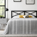 Modern master bedroom focal point featuring the Taylor black metal headboard by Malouf with industrial style.
