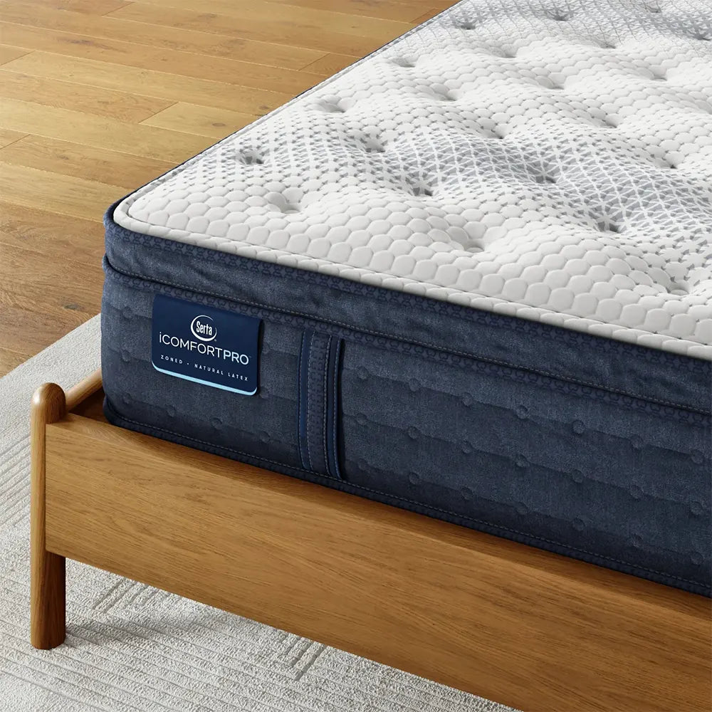 Detail of Serta iComfortPRO Dartmouth mattress branding on a supportive navy blue side panel.
