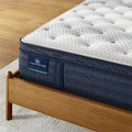 Detail of Serta iComfortPRO Dartmouth mattress branding on a supportive navy blue side panel.

