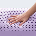 Hand pressing responsive lavender dough memory foam showing the plush, orthopedic support of the pillow.