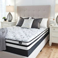 Supportive 8 inch firm mattress by Ashley Sleep styled on a traditional upholstered foundation.
