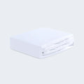 Folded white Dri-Tec crib sheet showing the smooth, high-performance breathable fabric.
