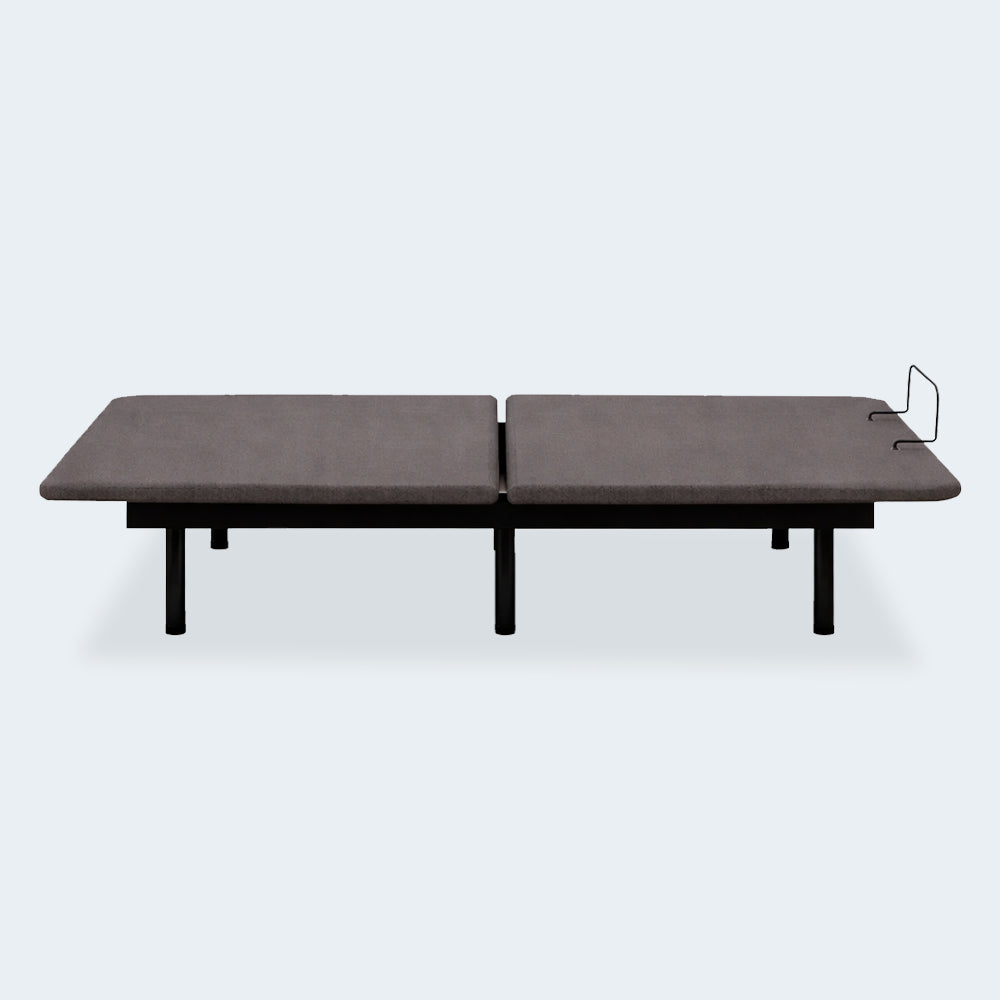 Side profile of the Ashley Comfort Classic adjustable bed base in a neutral flat position showing the low-profile frame and steel legs.
