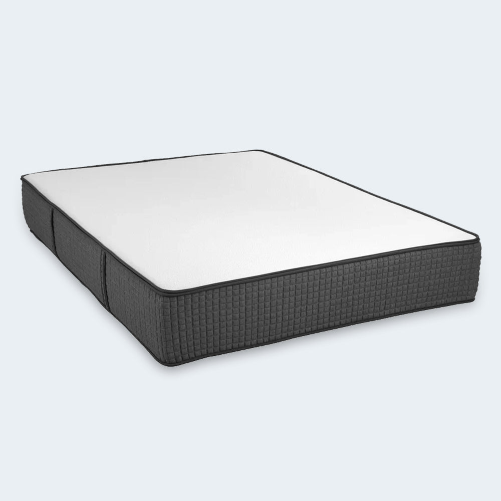 Isolated studio shot of the iSwitch 12-inch flippable two-sided mattress by South Bay featuring a white sleep surface and charcoal grey borders.
