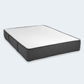 Isolated studio shot of the iSwitch 12-inch flippable two-sided mattress by South Bay featuring a white sleep surface and charcoal grey borders.
