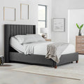 Front perspective of a fully made bed featuring the Malouf S755 adjustable base with head elevation and a charcoal fluted headboard.

