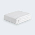 Folded white Hyper-Linen performance crib sheet by BEDGEAR for a clean, cool nursery environment.
