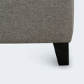 Close-up of the durable black tapered leg and upholstered corner of the Hudson platform bed frame.
