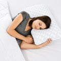 Woman using Malouf Shoulder Zoned Gel Dough pillow with Tencel cover for optimal side sleeper neck support.
