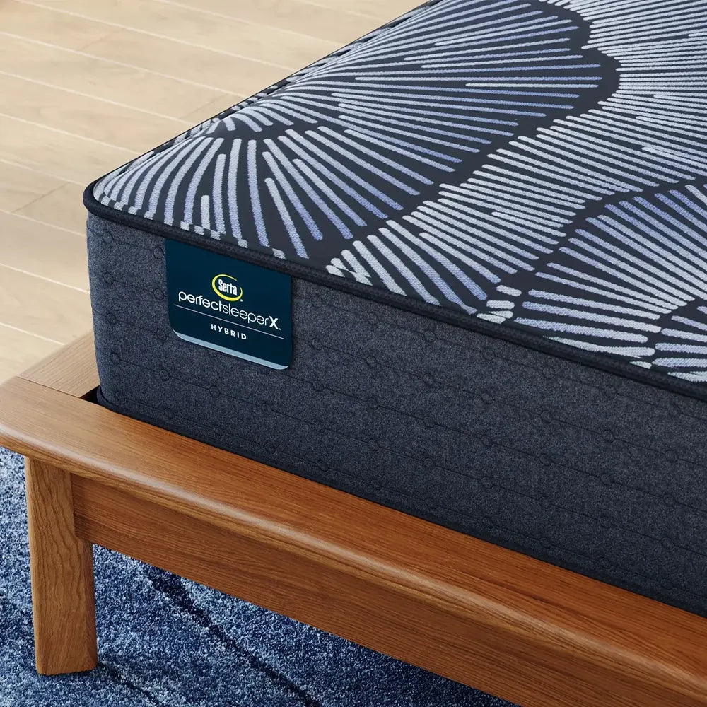 Detailed view of the Serta Perfect Sleeper X branding and plush smooth top fabric texture.
