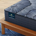 Detailed view of the Serta Perfect Sleeper X branding and plush smooth top fabric texture.
