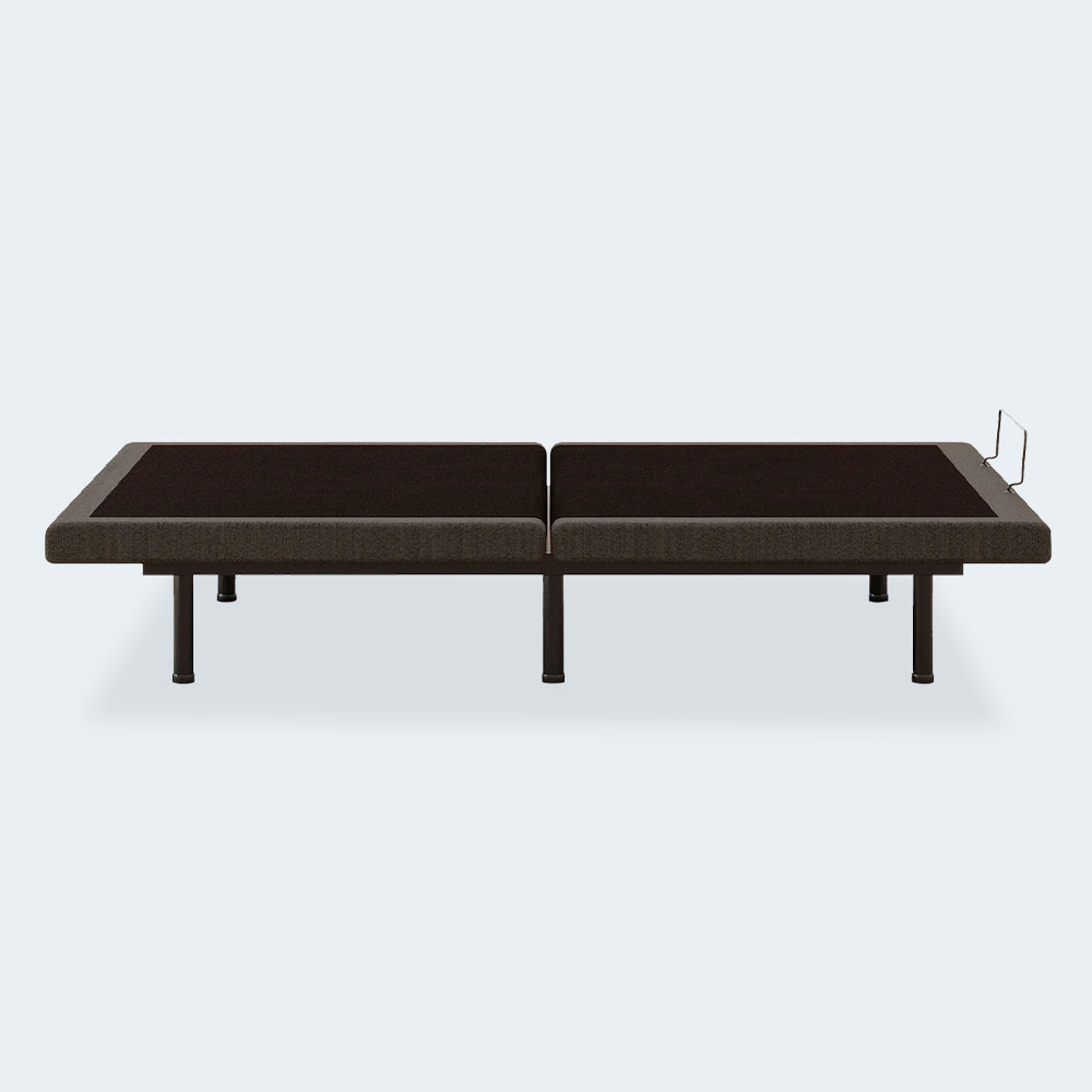 Side profile of the Comfort Premier Steel Adjustable Bed Base by Ashley in its neutral flat position showing the heavy-duty steel frame and legs.
