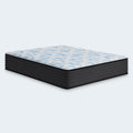 Angled profile shot of the 14-inch Elite Springs firm mattress by Ashley, highlighting the blue and white wave design on the quilted cover.
