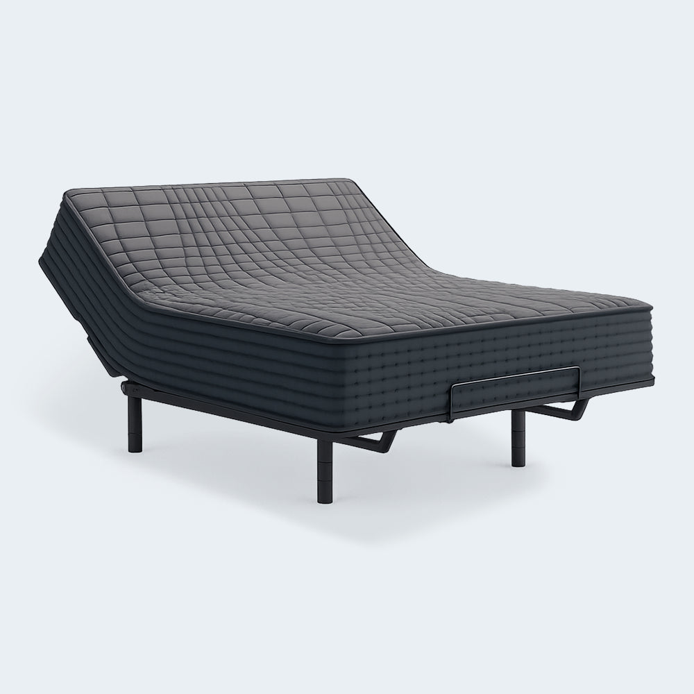 Gray 1200 Hybrid firm mattress with the head section elevated on an adjustable power base, showcasing flexible hybrid construction.
