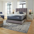 Modern luxury bedroom setting featuring the Ashley Millennium Gel Memory Foam Mattress on a grey upholstered bed frame with contemporary decor.
