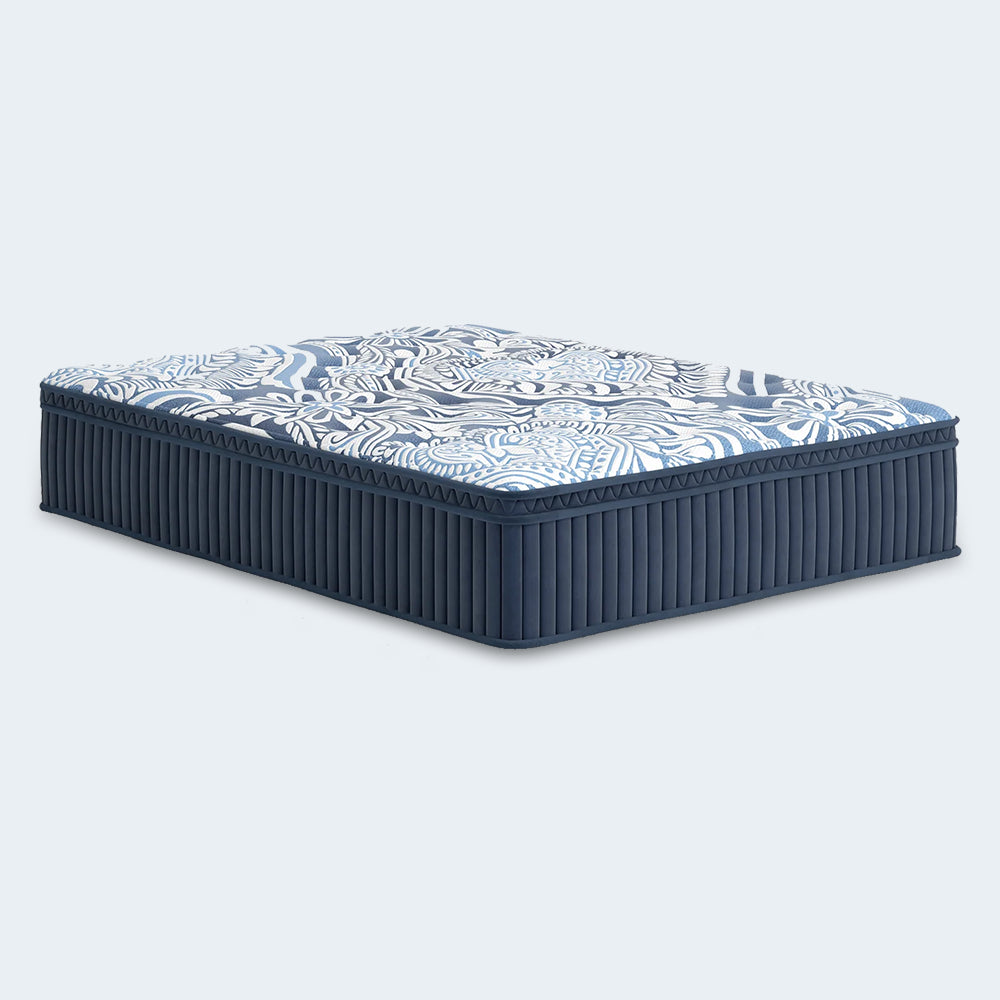Perspective studio shot of the Luxe 2.0 Blue 15-inch hybrid mattress showcasing the premium blue floral damask quilted cover.
