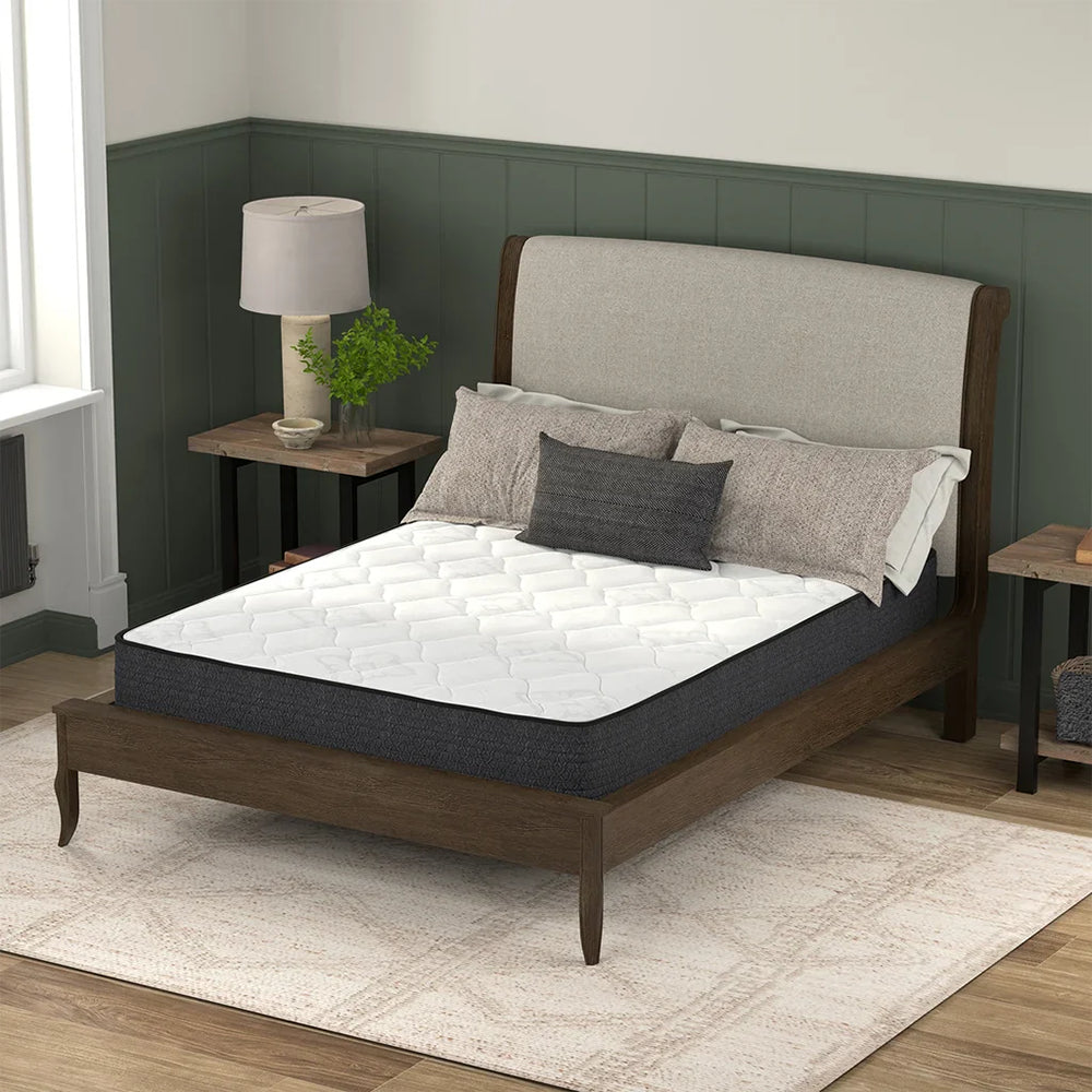 American Bedding Classic 8 Inch Medium Firm Innerspring Mattress by Corsicana styled on a dark wood bed frame in a modern bedroom.
