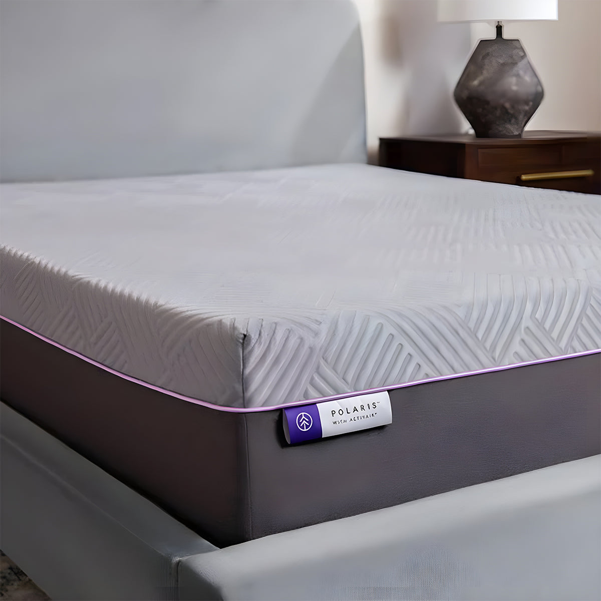 Close-up corner of the Polaris 12" Activair Hybrid Mattress with purple piping and Activair branding tag.
