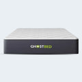 Front-facing view of the GhostBed 12-inch Hybrid medium-soft mattress with a white diamond-quilted cover and charcoal grey sides.
